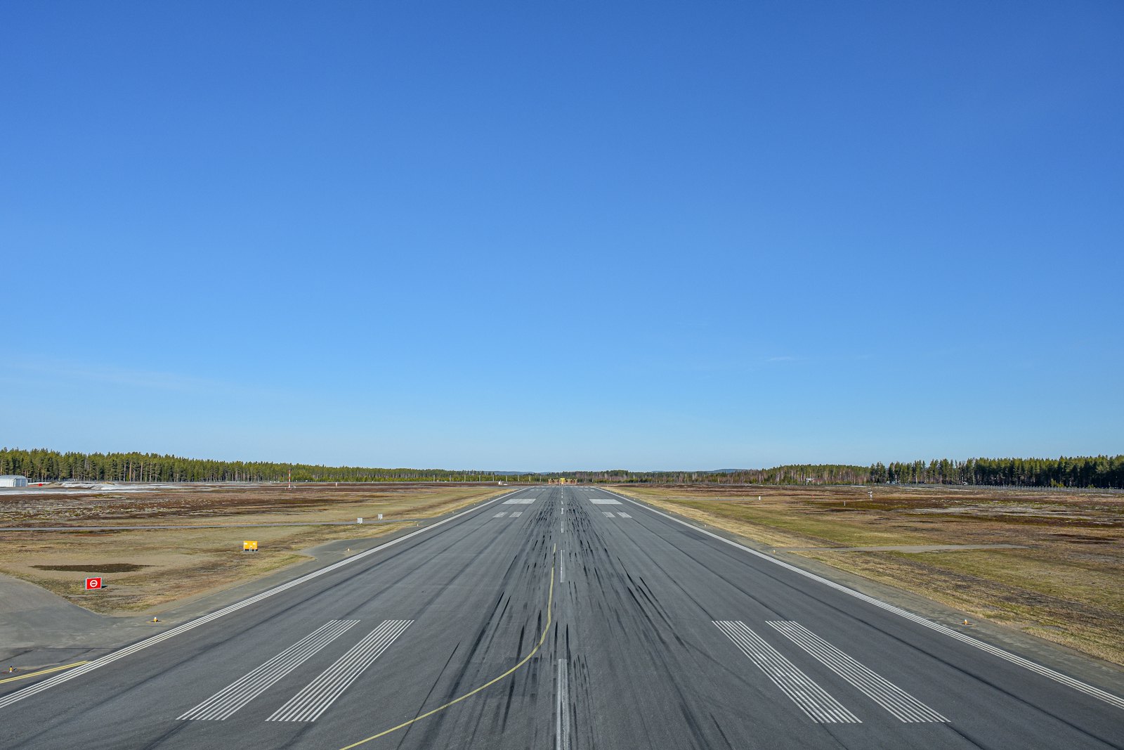 An airport runway stretching toward low coastal hills (placeholder photo)